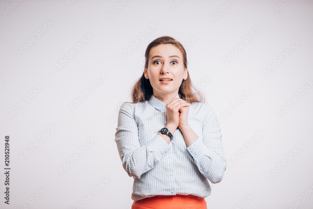 Attractive young woman looks at camera in surprise on white background, Emotional expression Attractive young woman looks at camera in surprise on white background, Emotional expression