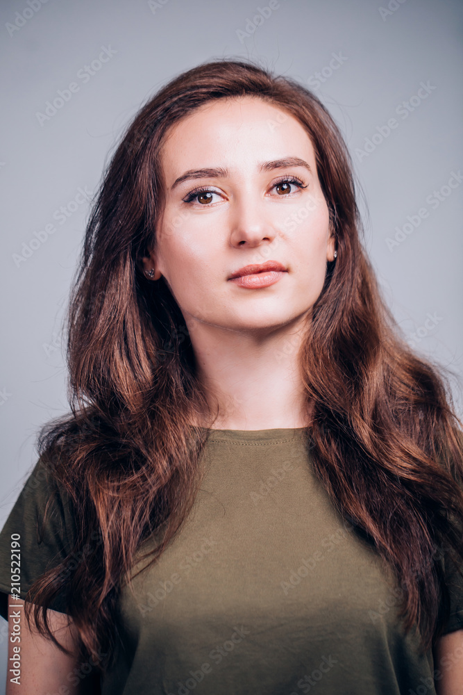 Close up portrait of beautiful cute brunette woman on grey background. Close up portrait of beautiful cute brunette woman on grey background.