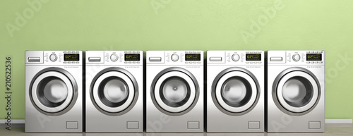 Cuadro en lienzo Clothes washers, dryer machines on wooden floor, green wall background, banner