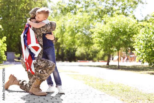 American soldier with her son outdoors. Military service