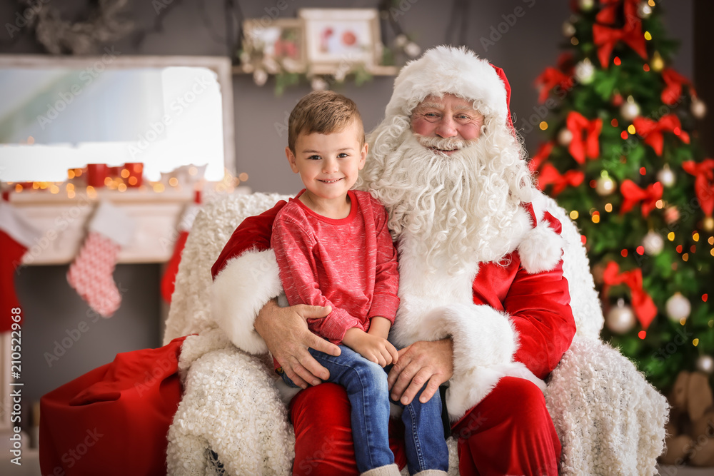 Little boy sitting on authentic Santa Claus' lap indoors Little boy sitting on authentic Santa Claus' lap indoors