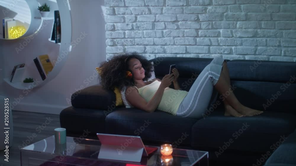 Happy Latino Woman Watching Video On Phone