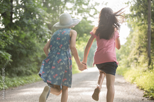 Best friends running carefree heading out for a summer adventure © Christine Glade