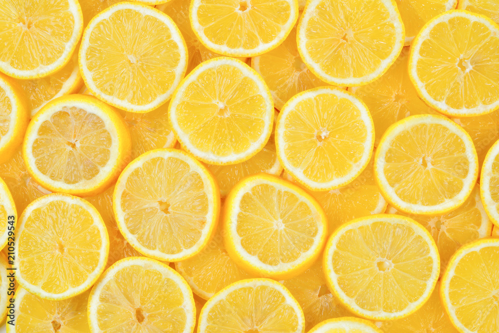 A slices of fresh juicy yellow lemons.  Texture background, pattern