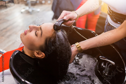 Spa hair treatment brunette women in the salon, close-up, hair salon