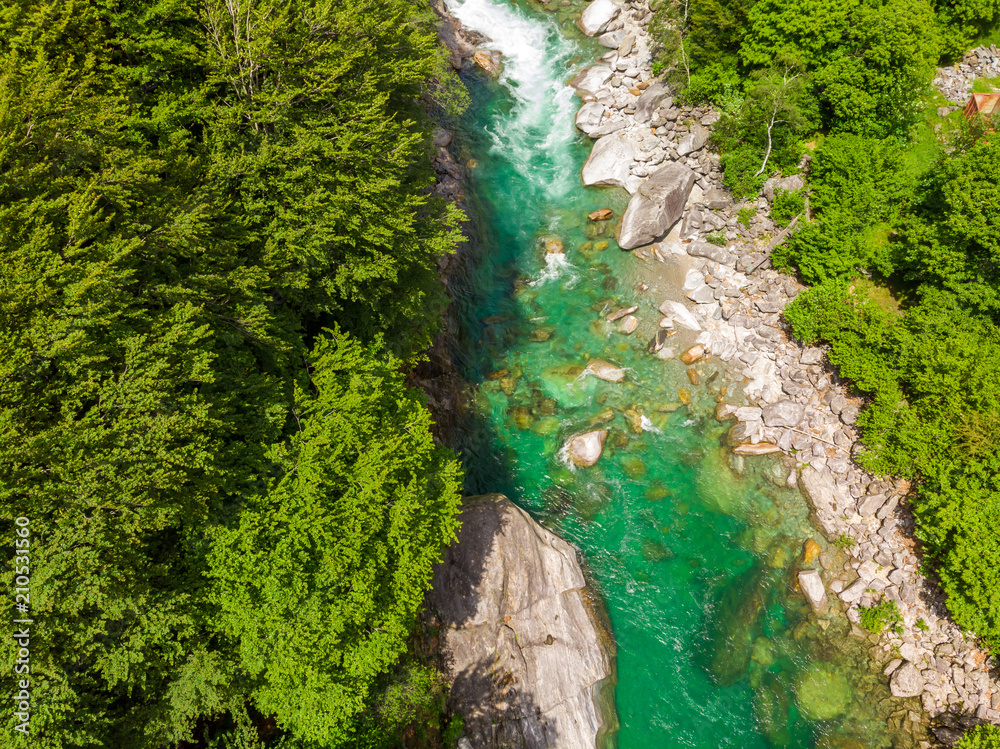 Valle Verzasca - Aerial View of clear and turquoise water stream and rocks in Verzasca River in Ticino - Verzasca Valley in Tessin, Switzerland Valle Verzasca - Aerial View of clear and turquoise water stream and rocks in Verzasca River in Ticino - Verzasca Valley in Tessin, Switzerland