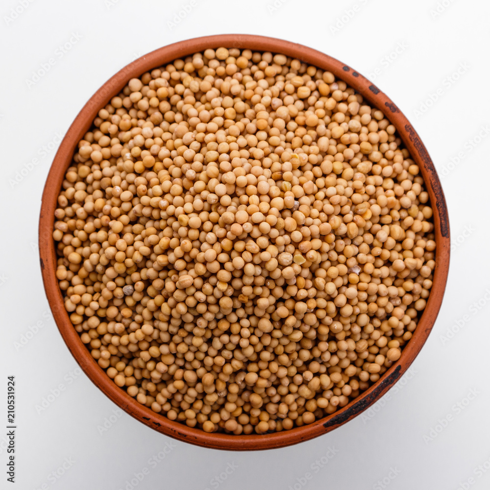 fragrant grains of mustard on a white background fragrant grains of mustard on a white background