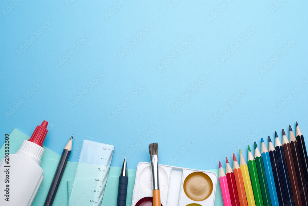 Obraz premium Set of the school supplies on a blue background, with place for your text on a top.