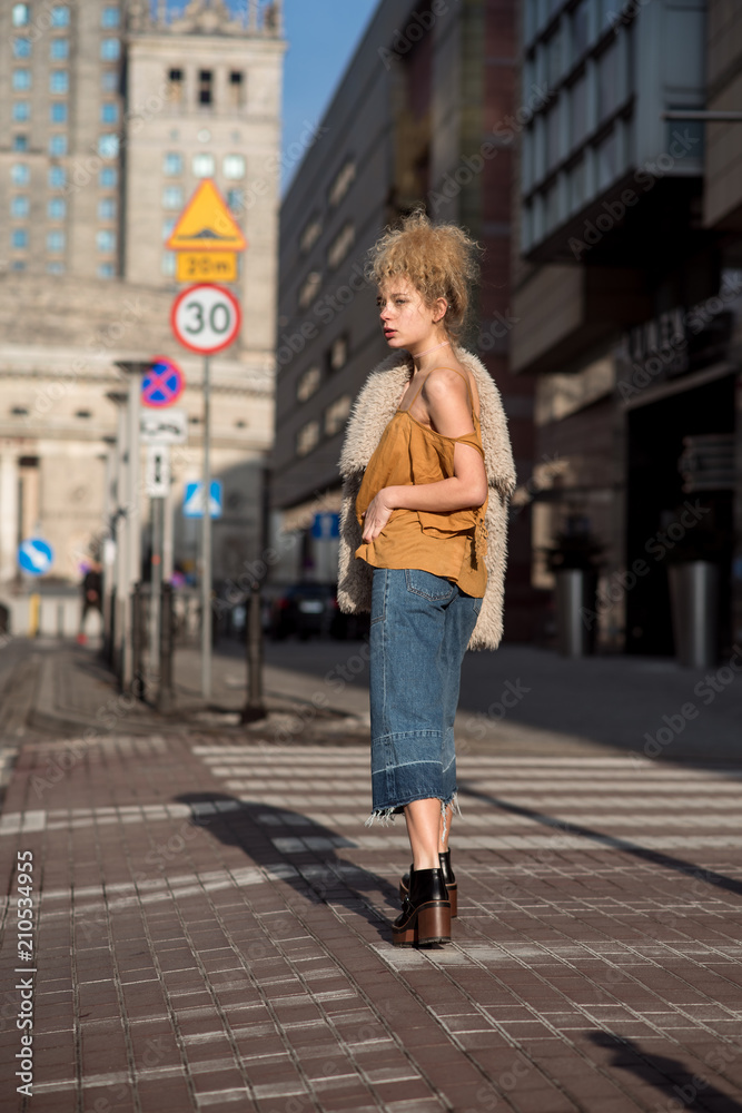 beautiful girl walking through the city streets