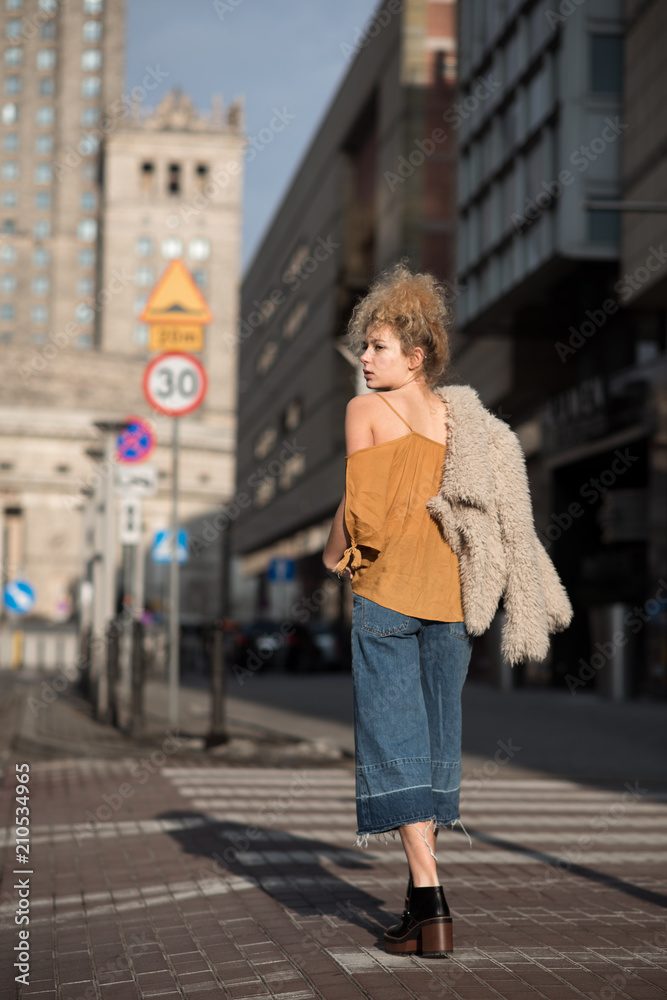 beautiful girl walking through the city streets beautiful girl walking through the city streets
