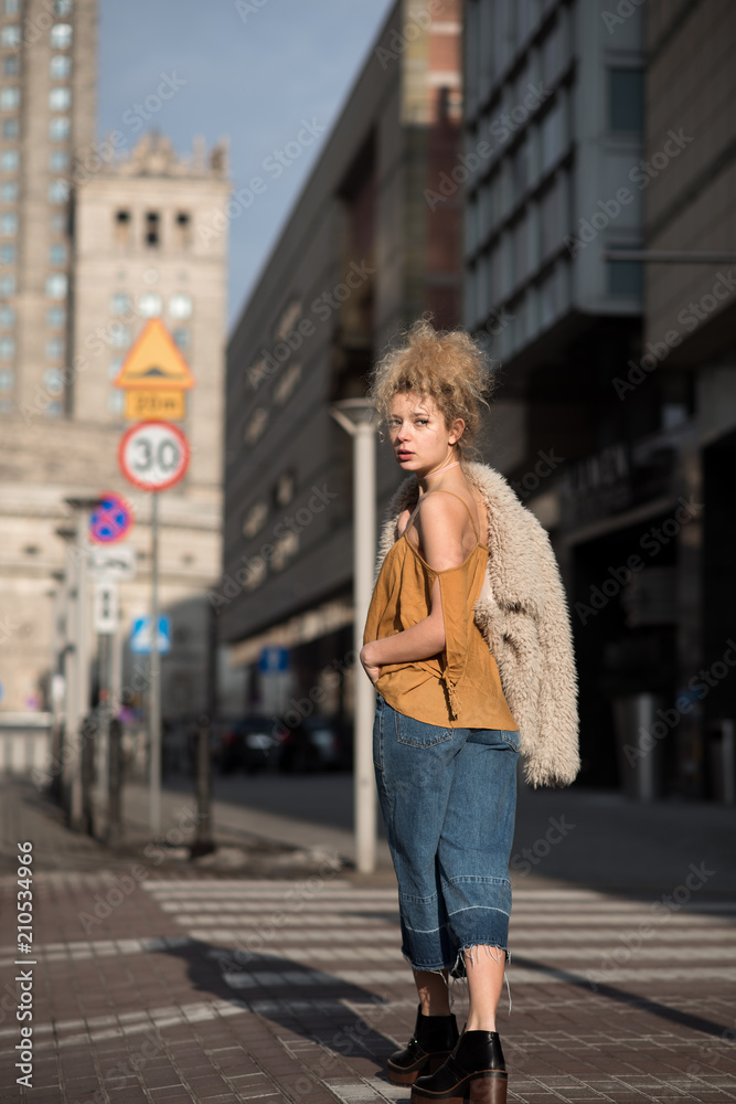 beautiful girl walking through the city streets