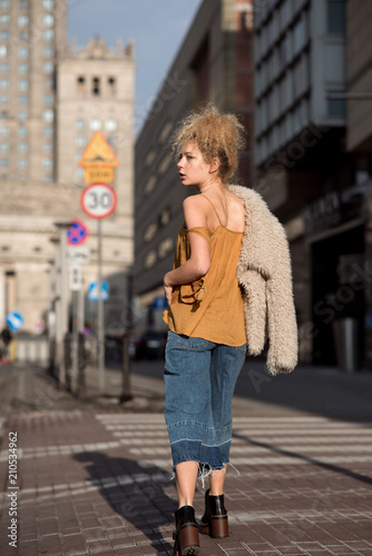 beautiful girl walking through the city streets