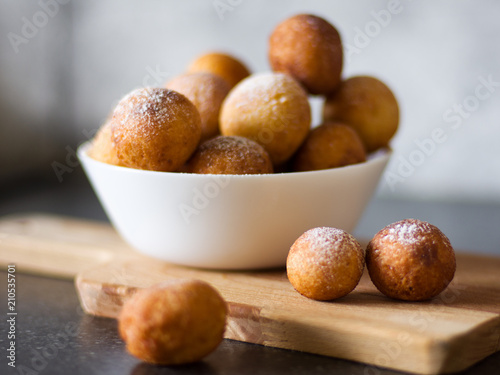 Donuts from cottage cheese  delicious dessert. Close-up. Soft focus. Donuts in Italian on a wooden board