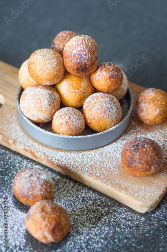 Donuts from cottage cheese, delicious dessert. Close-up. Soft focus. Donuts in Italian on a wooden board photo