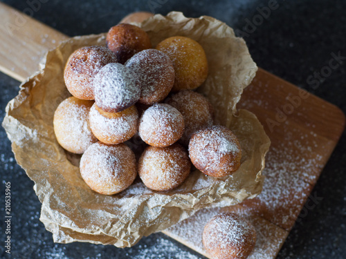 Donuts close-up. Italian fritters - traditional dish on a gray background on a wooden board. photo