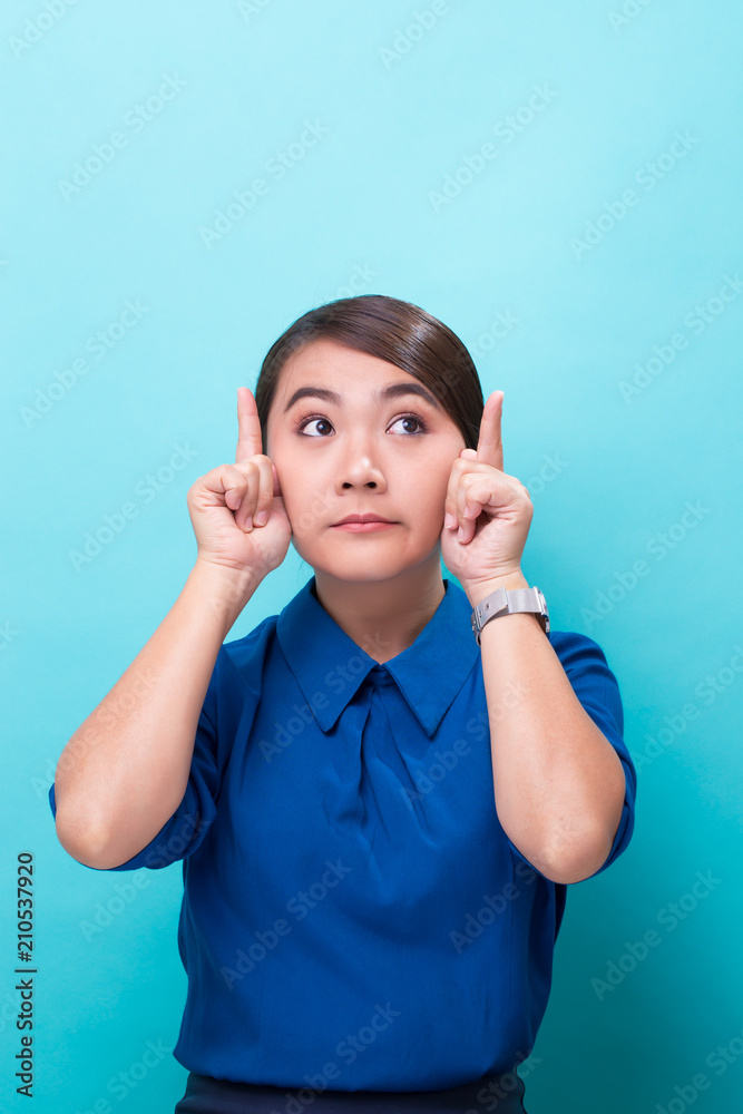 Fototapeta premium Surprised woman on isolated blue background