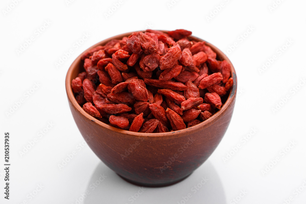 dried goji berries on a white acrylic background dried goji berries on a white acrylic background