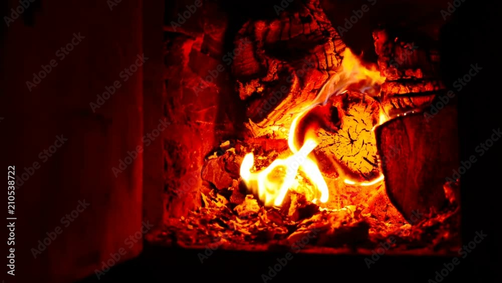 The firewood is burning in the fireplace. beautiful glow The firewood is burning in the fireplace. beautiful glow