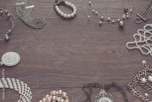 Set of vintage jewelry on a dark wooden background.