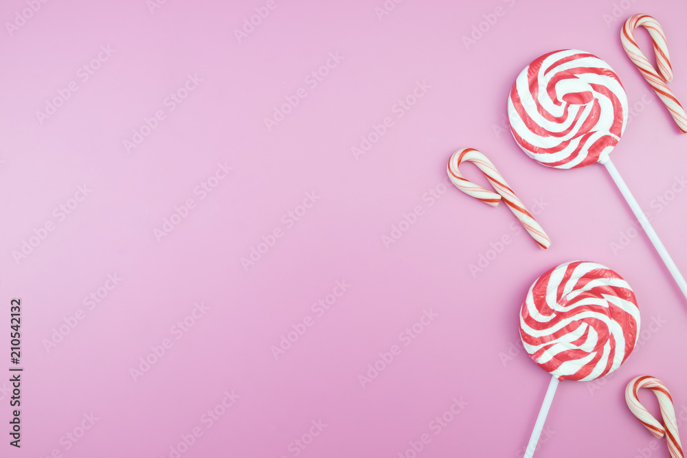 Flat lay top view tasty appetizing concept, minimal Sweet Treat Swirl Candy Lollipop marshmallow Colorful pattern on pink pastel background and copy space. Flat lay top view tasty appetizing concept, minimal Sweet Treat Swirl Candy Lollipop marshmallow Colorful pattern on pink pastel background and copy space.