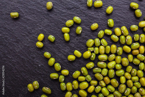 fresh Mung beans on a dark stone background