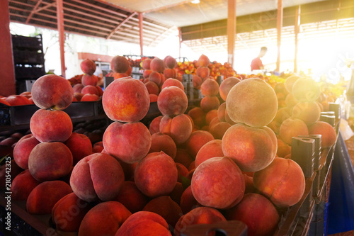 Peaches and nectarines on the counter are sold at the grocery store. photo