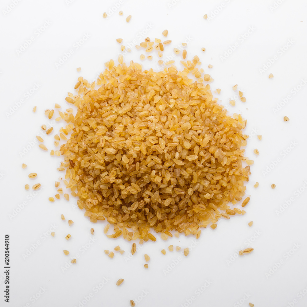raw bulgur on a white acrylic background raw bulgur on a white acrylic background
