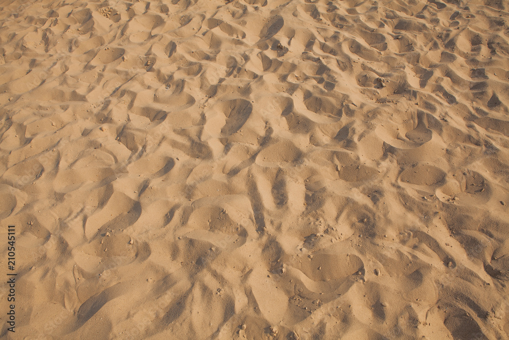 Closeup of sand pattern of a beach in the summer. Background.concept for summer season Closeup of sand pattern of a beach in the summer. Background.concept for summer season