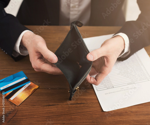 Man showing empty wallet without cash photo