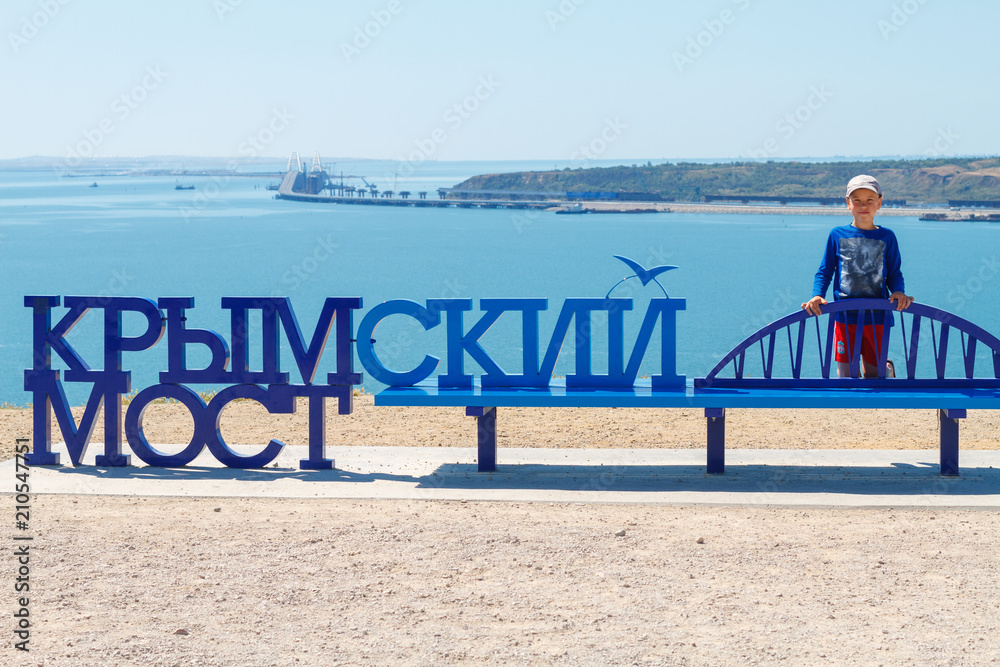 boy on the background of the sea near the inscription Crimean bridge boy on the background of the sea near the inscription Crimean bridge