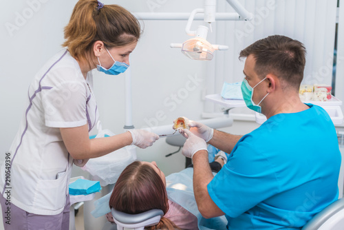 doctor orthodontist explains to the patient how he will treat her