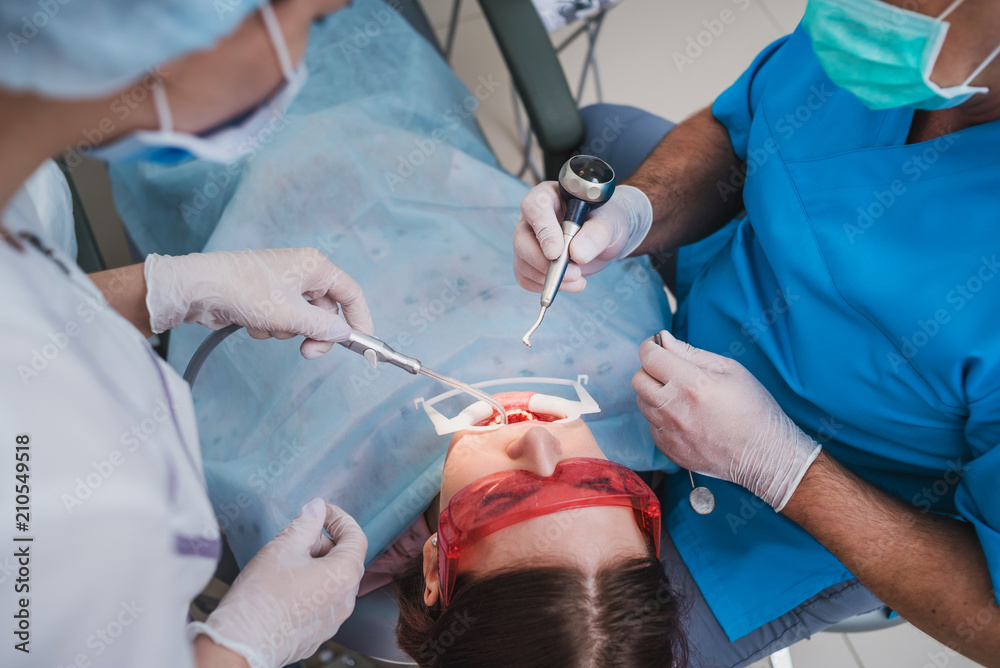 doctor orthodontist performs a procedure for cleaning teeth doctor orthodontist performs a procedure for cleaning teeth