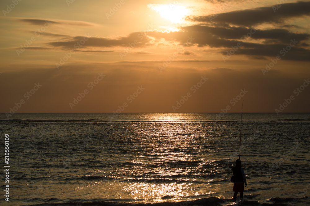 Fishing man at sunset