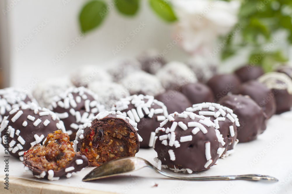 Vegan sweets made from prunes, dates, almonds, sesame, nuts, hazelnuts, nuts, chocolate, goji berries