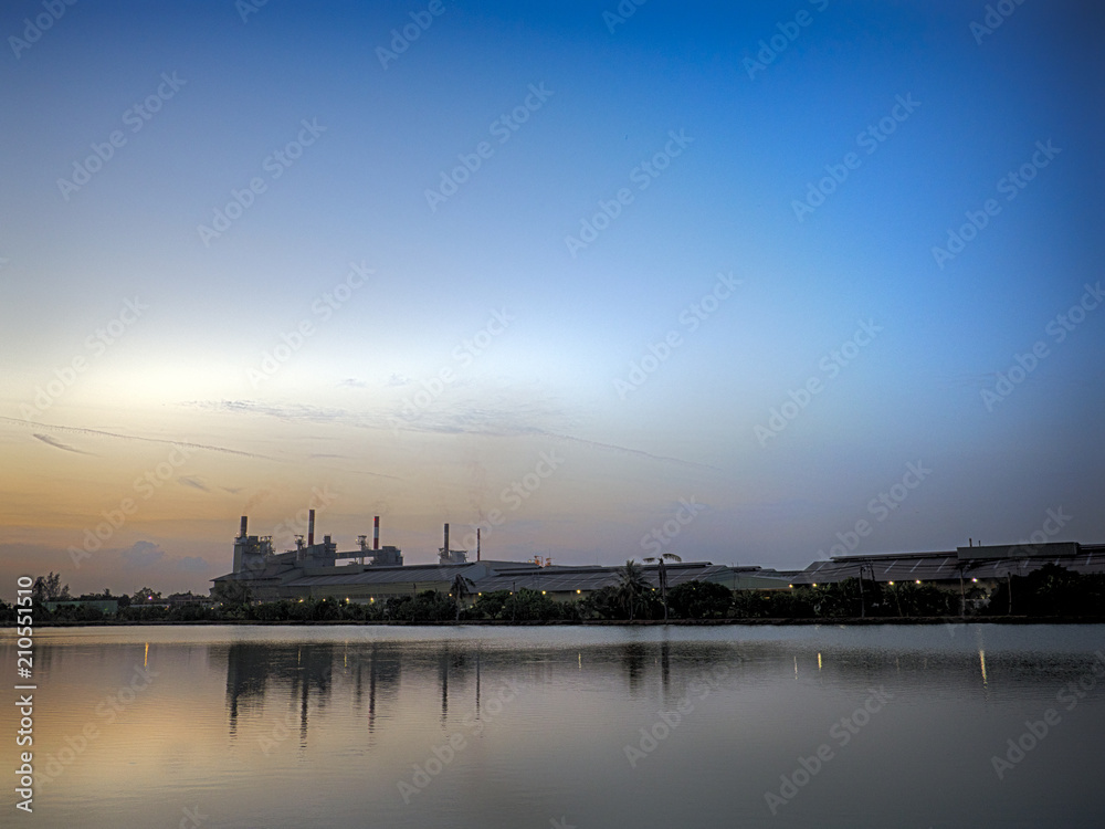 Beautiful landscape: river and silhouette of the city on the horizon, sunset