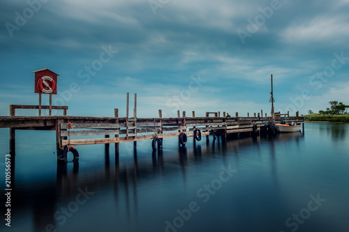 wooden jetty with life jacket and boat © Kilman Foto