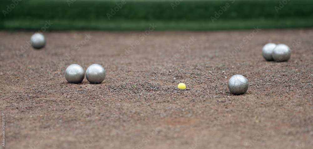 Metallic petanque four balls and a small wood jack