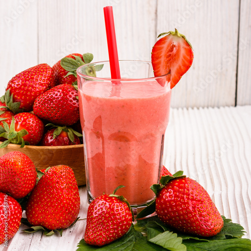 fresh strawberrysmoothie or milkshake on a wooden rustic background photo