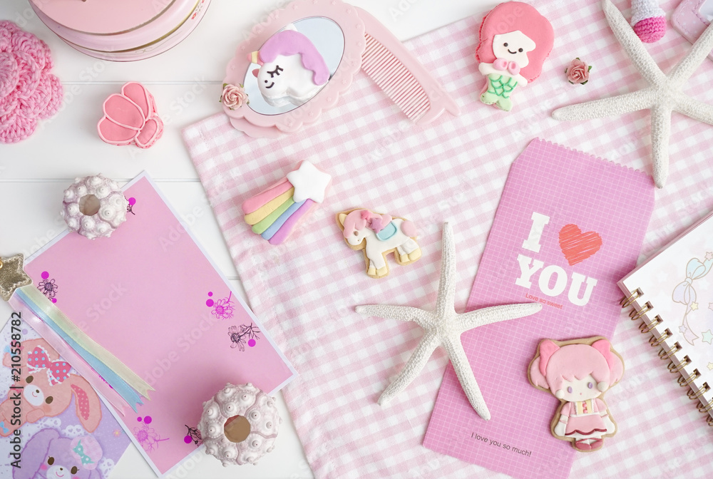Fairy tales concept in pink and white. Cute macarons of mermaid and unicorn. Top view. Empty pink postcard is for your personalized text. Fairy tales concept in pink and white. Cute macarons of mermaid and unicorn. Top view. Empty pink postcard is for your personalized text.