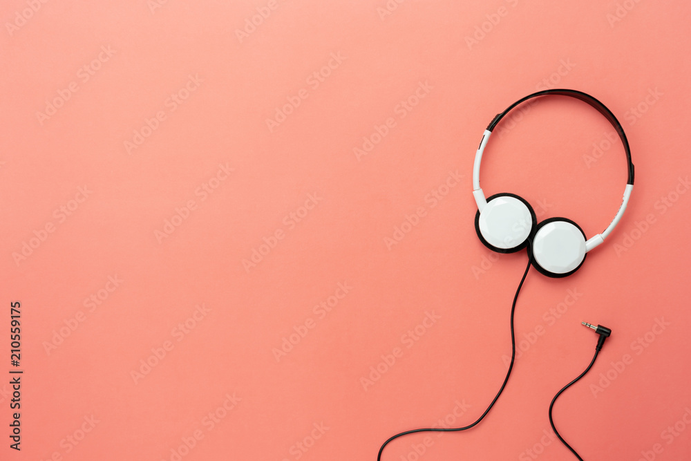 Table top view aerial image of accessories listening radio music background   lay white headphones on modern rustic pink paper   space for creative design text and content. Stock Photo | Adobe