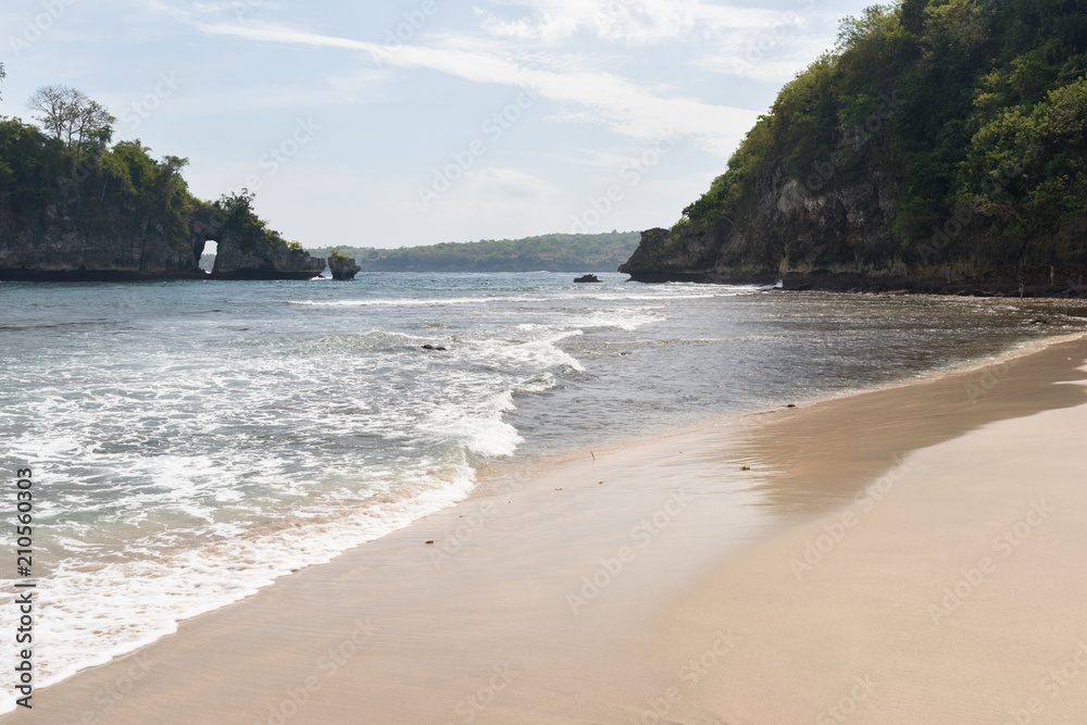 A popular beach between two rocks on the island of Nusa Penida in Indonesia