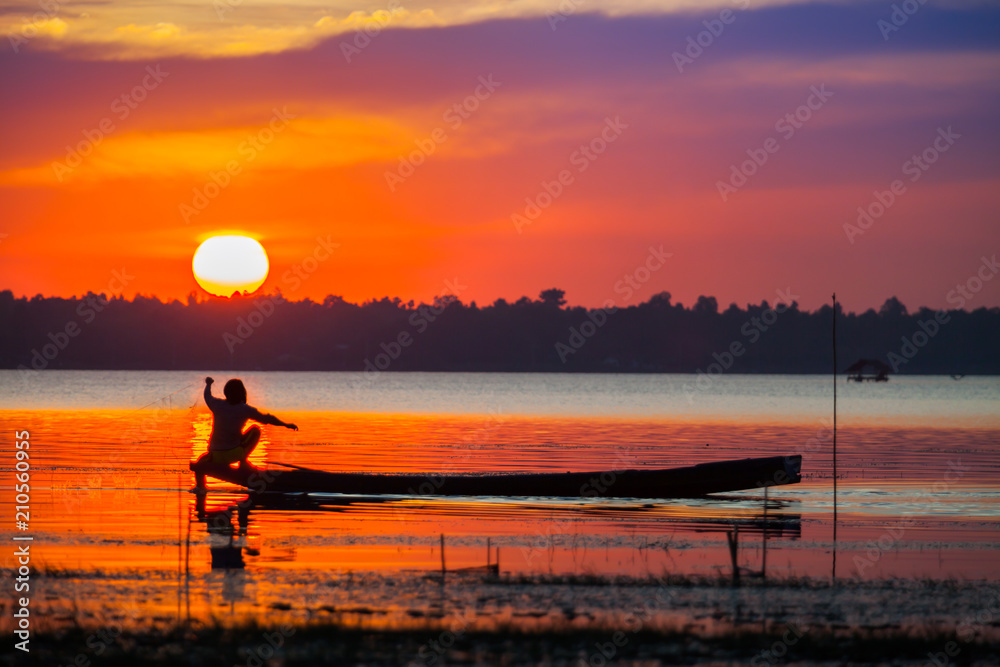 Colorful of sunset timing reflection on sea with longboat foreground 
