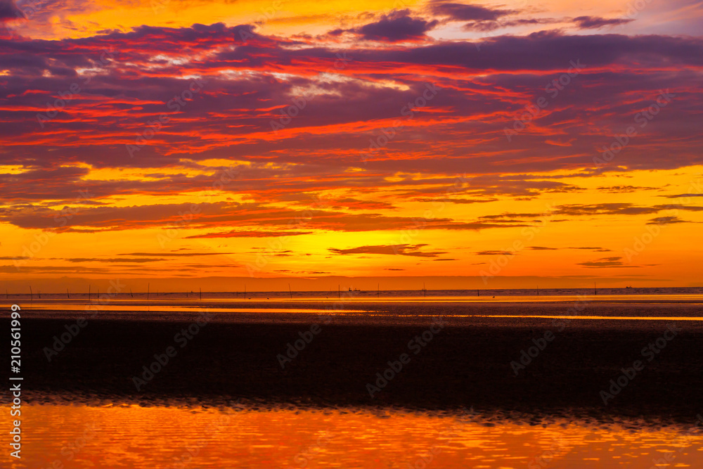 Colorful sky on beautiful beach at sunrise timing located at south of Thailand