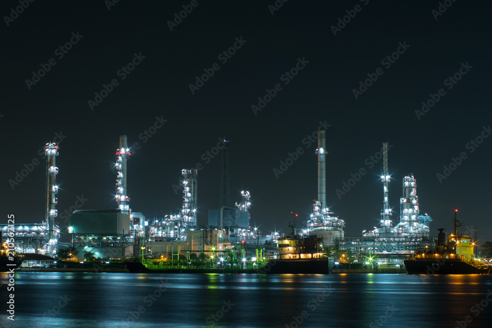Power plant with shipping boat at night time Power plant with shipping boat at night time