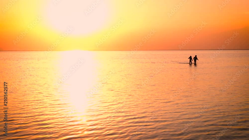 children walking by the sea at the sunset time
children walking by the sea at the sunset time