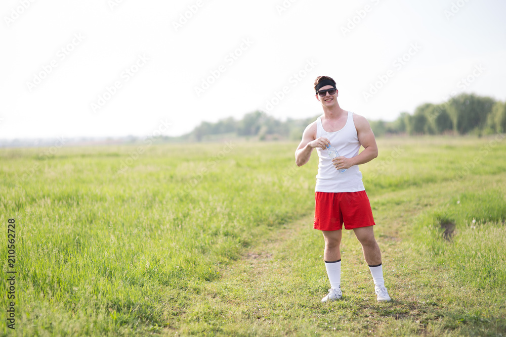 young man is standing on the grass