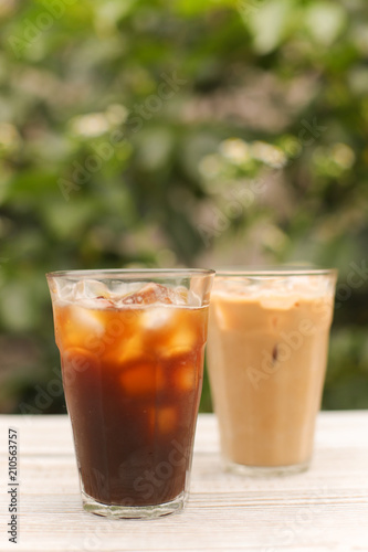 Iced coffee black coffee and latte isolated on green
