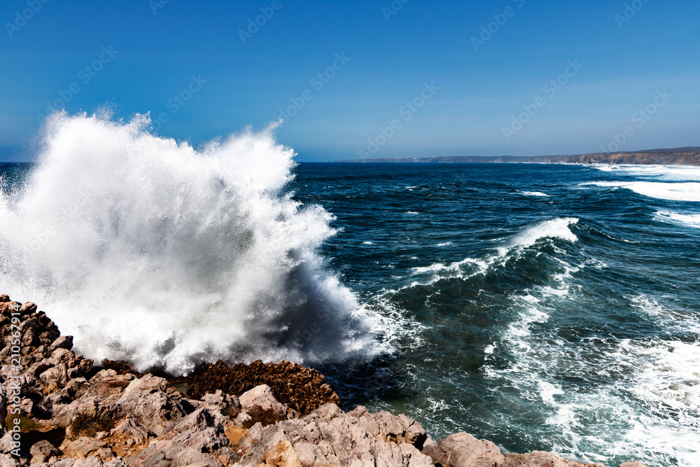 Waves against rough cliffs.
