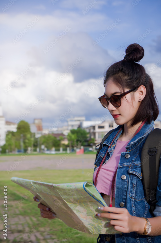 traveler girl's hold a map and looking for destination