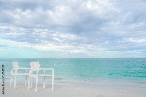 Summer concept , White chair on the beach white sand and turquoise sea color at maldives on the weekend holidays © godshutter